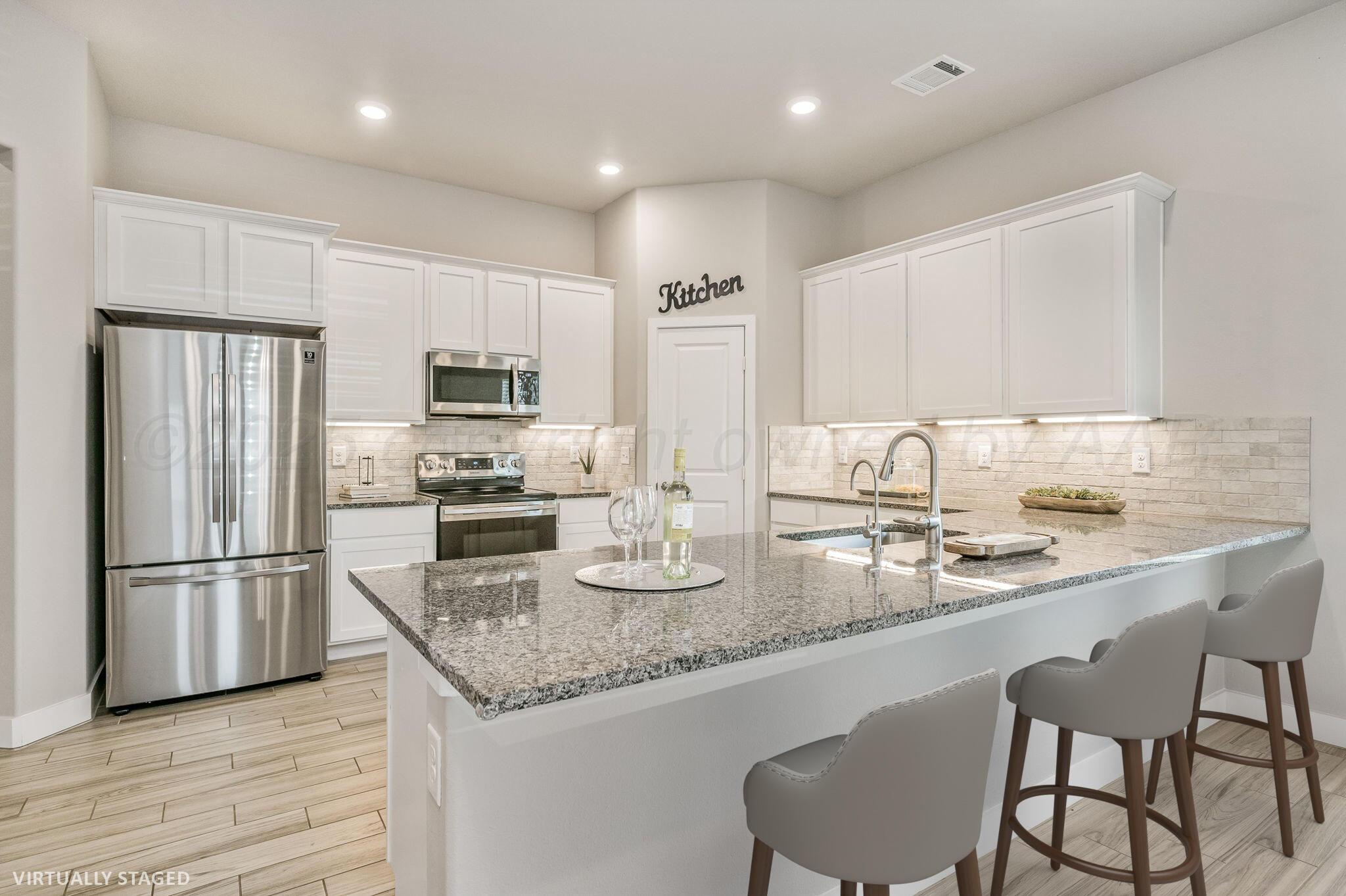 9209 Lexford Drive Amarillo, TX 79119 - Photo 4 of 23 a kitchen with granite countertop kitchen island cabinets and stainless steel appliances