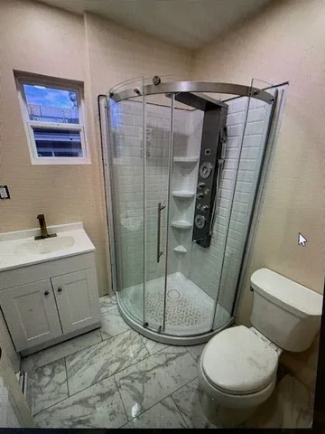 a bathroom with a sink toilet and shower