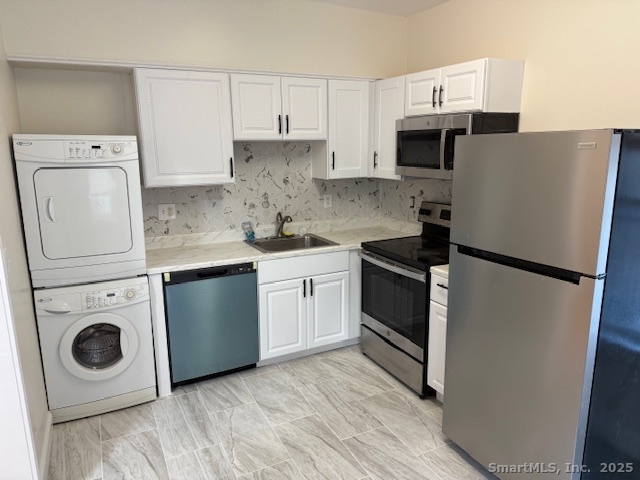 253 Hope Street Stamford, CT 06906 - Photo 11 of 11 a kitchen with a refrigerator sink stove and white cabinets