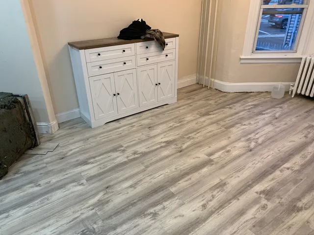 a view of a dresser with wooden floor