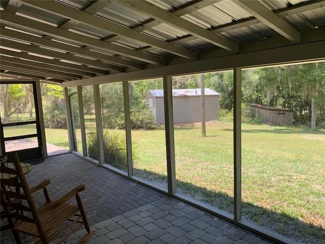 a kitchen with a table chairs sink and wooden floor