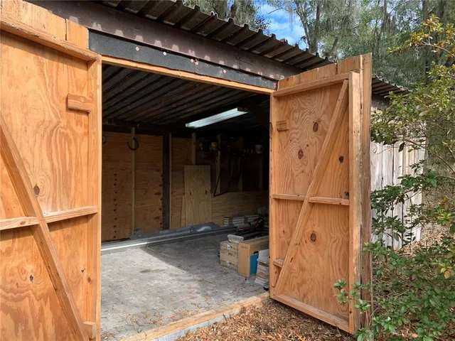 a view of a backyard with large trees
