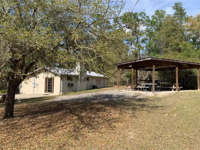 a front view of house with yard and trees