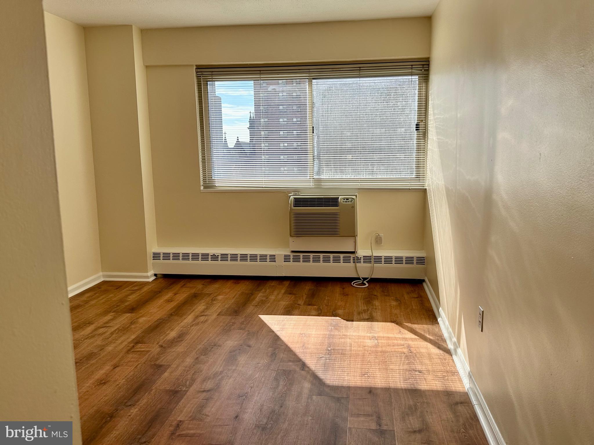 2101 Chestnut Street, Unit 811 Philadelphia, PA 19103 - Photo 14 of 17 a view of a room with wooden floor and a large window