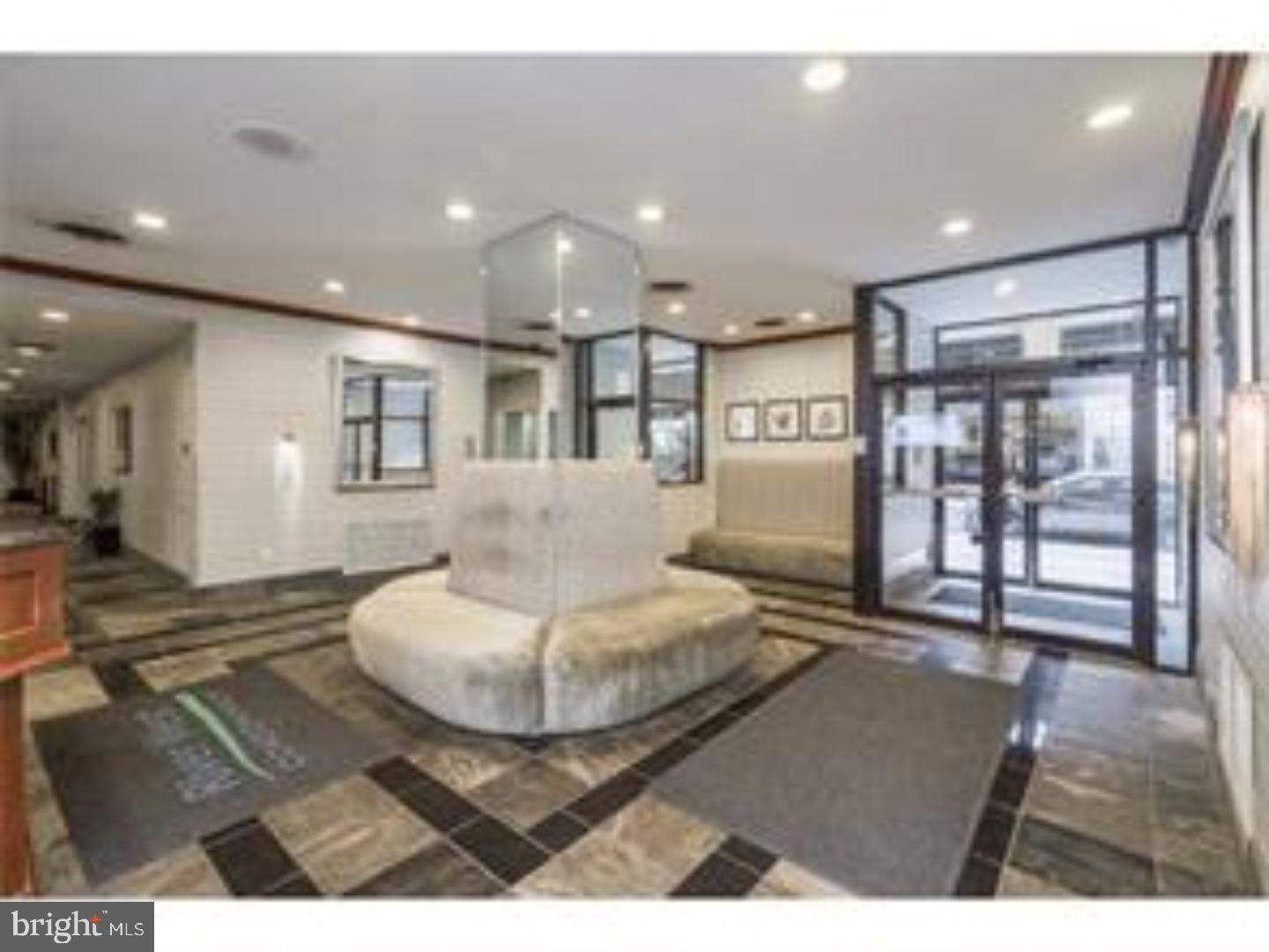 2101 Chestnut Street, Unit 811 Philadelphia, PA 19103 - Photo 2 of 17 a living room with furniture and a table