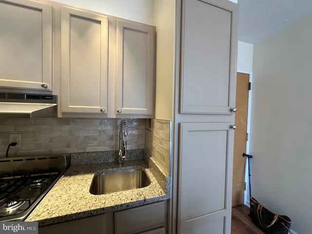 a kitchen with a sink and cabinets