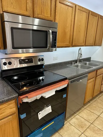 a kitchen with a stove microwave and sink