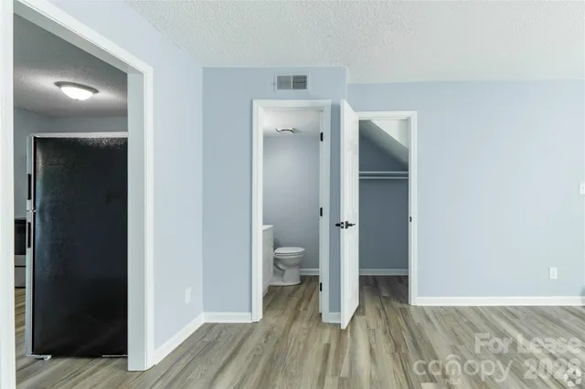 a view of a room with wooden floor