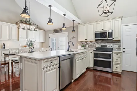 a kitchen with a sink stove and cabinets