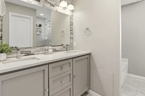 a bathroom with a sink vanity and a mirror