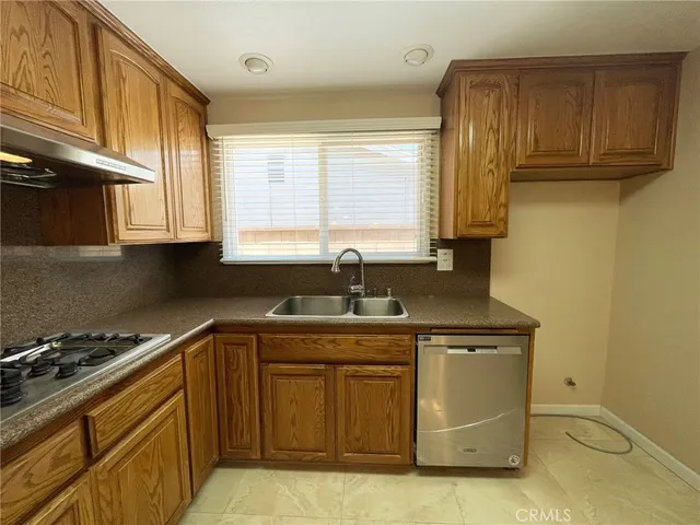a kitchen with stainless steel appliances granite countertop a sink stove and cabinets