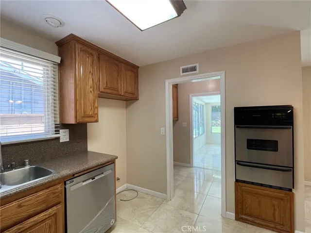 a kitchen with a refrigerator and a sink