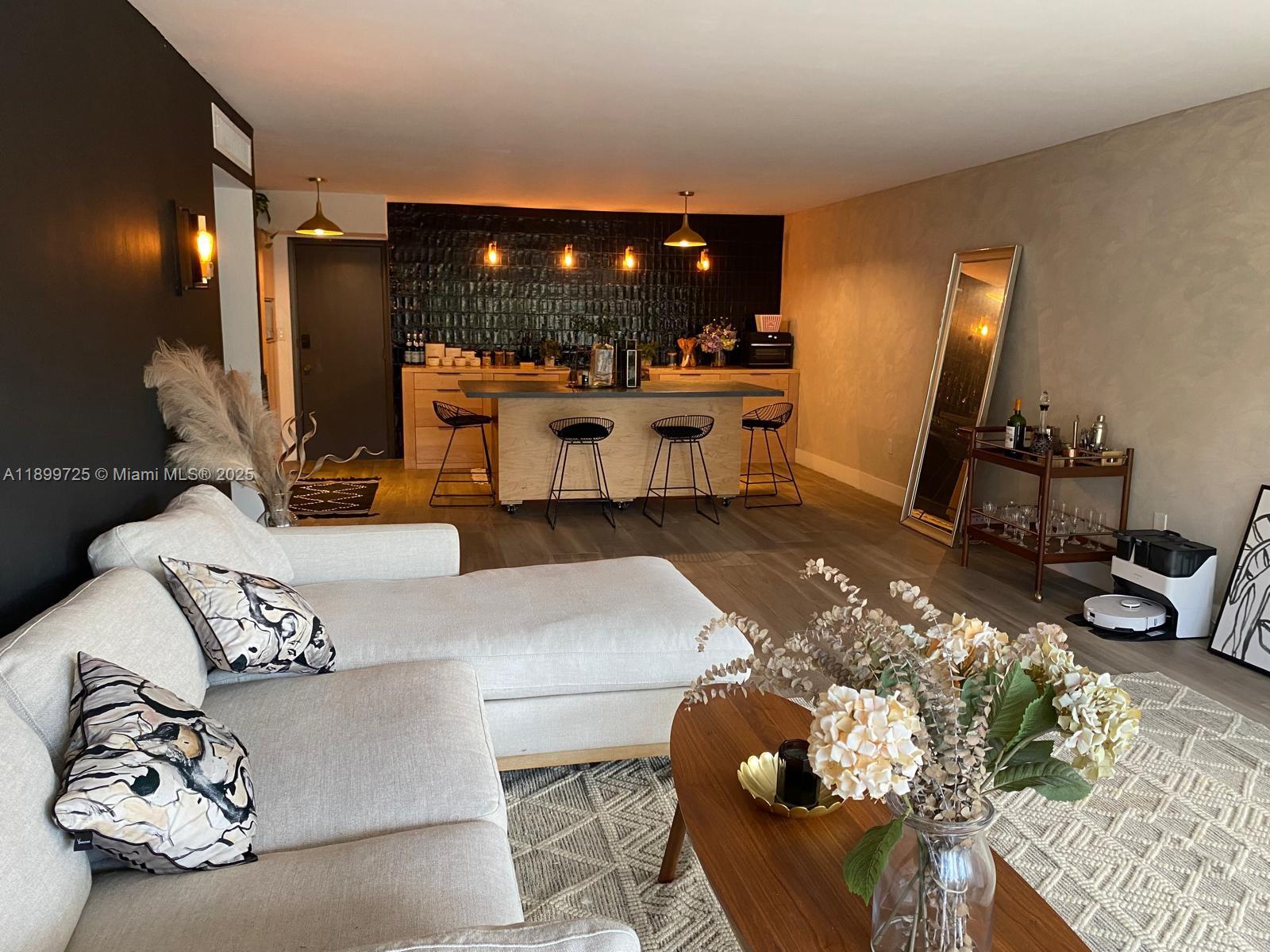 a living room with furniture and kitchen view