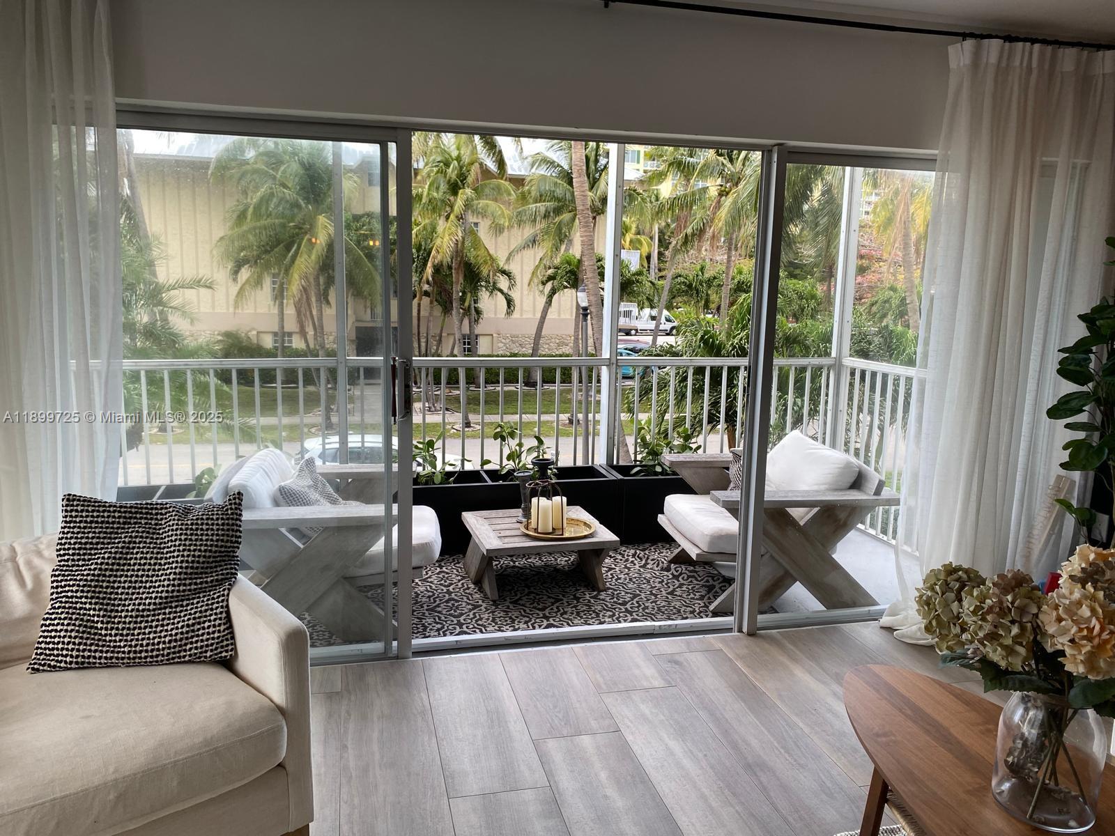 550 Ocean Drive, Unit 2D Key Biscayne, FL 33149 - Photo 12 of 35 a living room with furniture and a floor to ceiling window