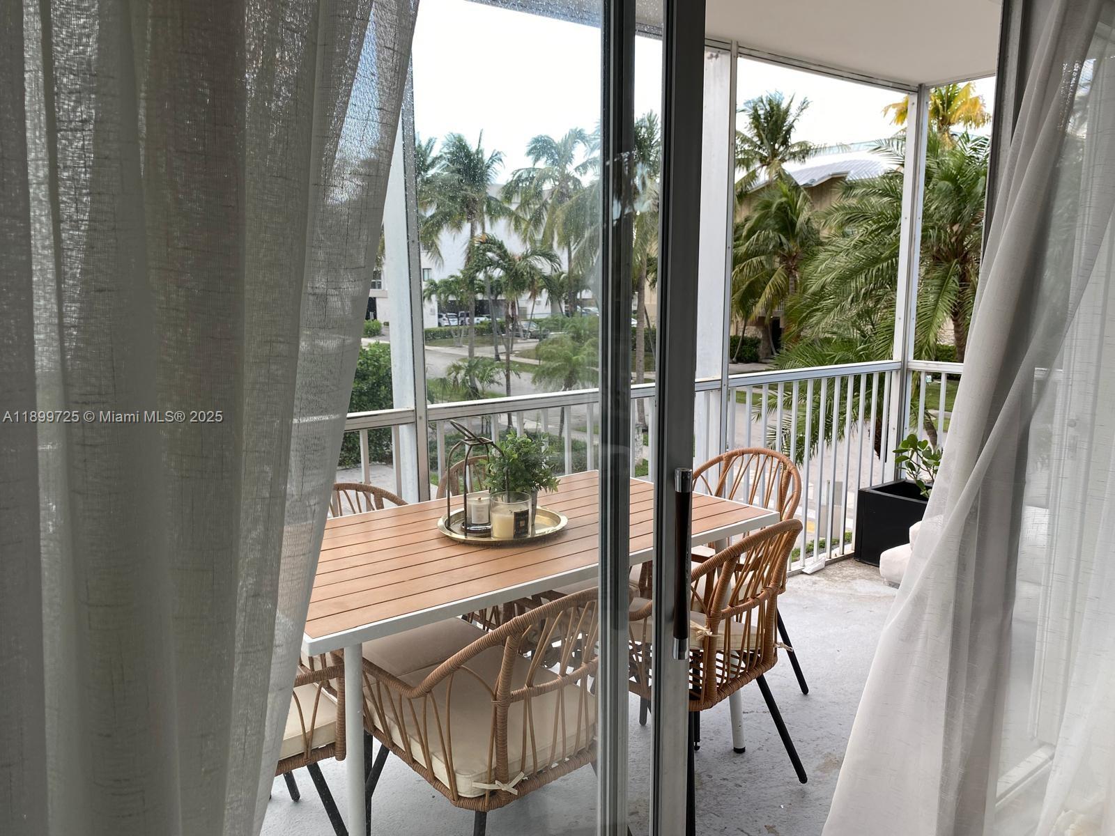 550 Ocean Drive, Unit 2D Key Biscayne, FL 33149 - Photo 16 of 35 a view of a balcony and dining room
