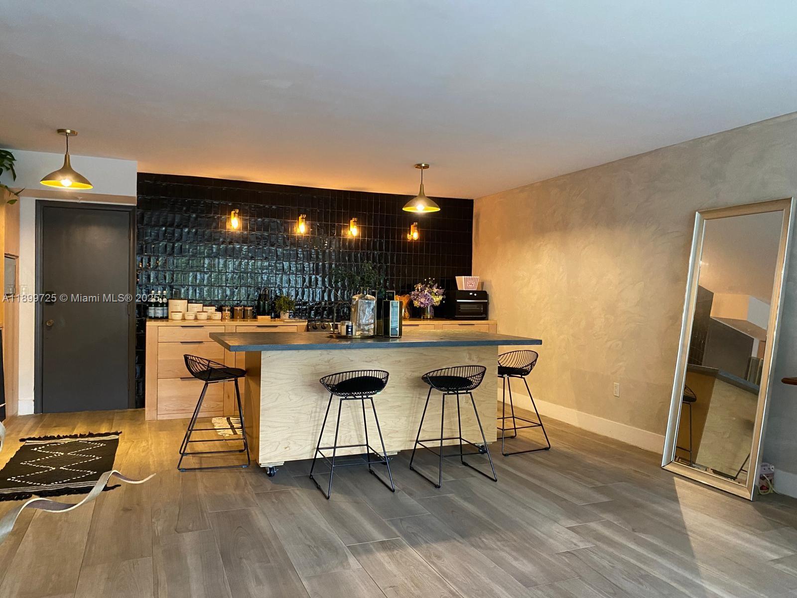 550 Ocean Drive, Unit 2D Key Biscayne, FL 33149 - Photo 17 of 35 a view of a kitchen with dining table and chairs