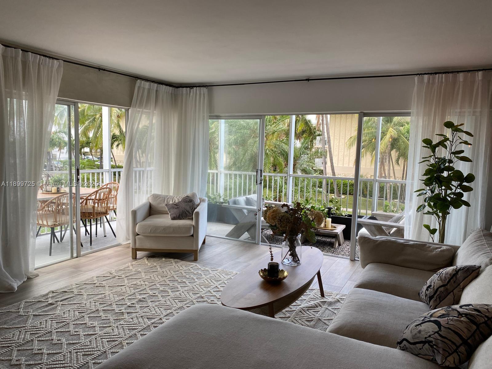 550 Ocean Drive, Unit 2D Key Biscayne, FL 33149 - Photo 18 of 35 a living room with furniture and a large window