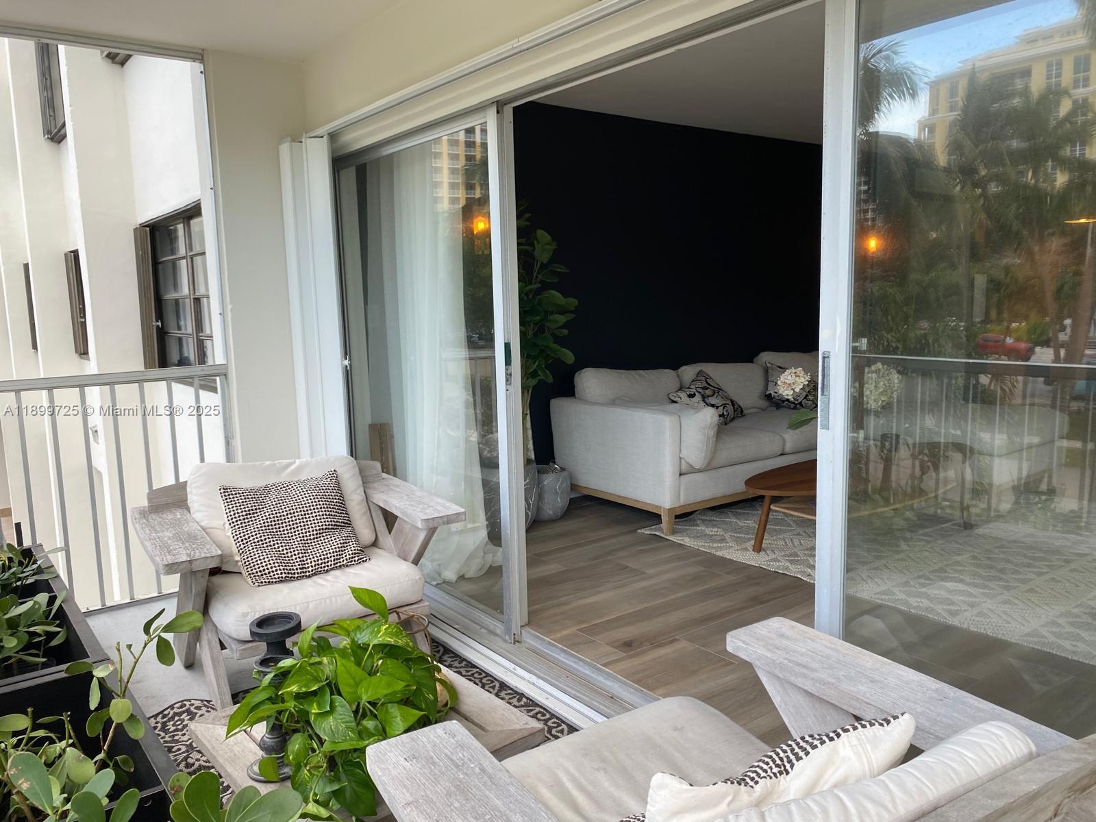 550 Ocean Drive, Unit 2D Key Biscayne, FL 33149 - Photo 19 of 35 a living room with furniture and a potted plant