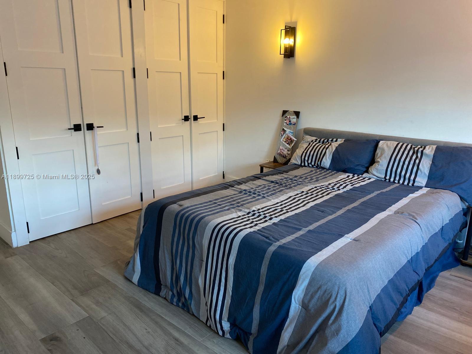 550 Ocean Drive, Unit 2D Key Biscayne, FL 33149 - Photo 20 of 35 a bedroom with a bed and a table