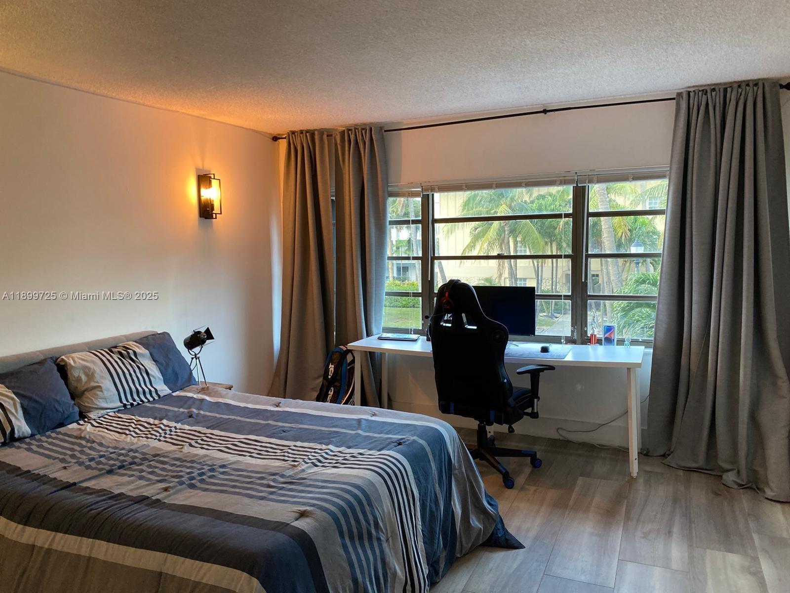 550 Ocean Drive, Unit 2D Key Biscayne, FL 33149 - Photo 21 of 35 a bedroom with a bed and a large window