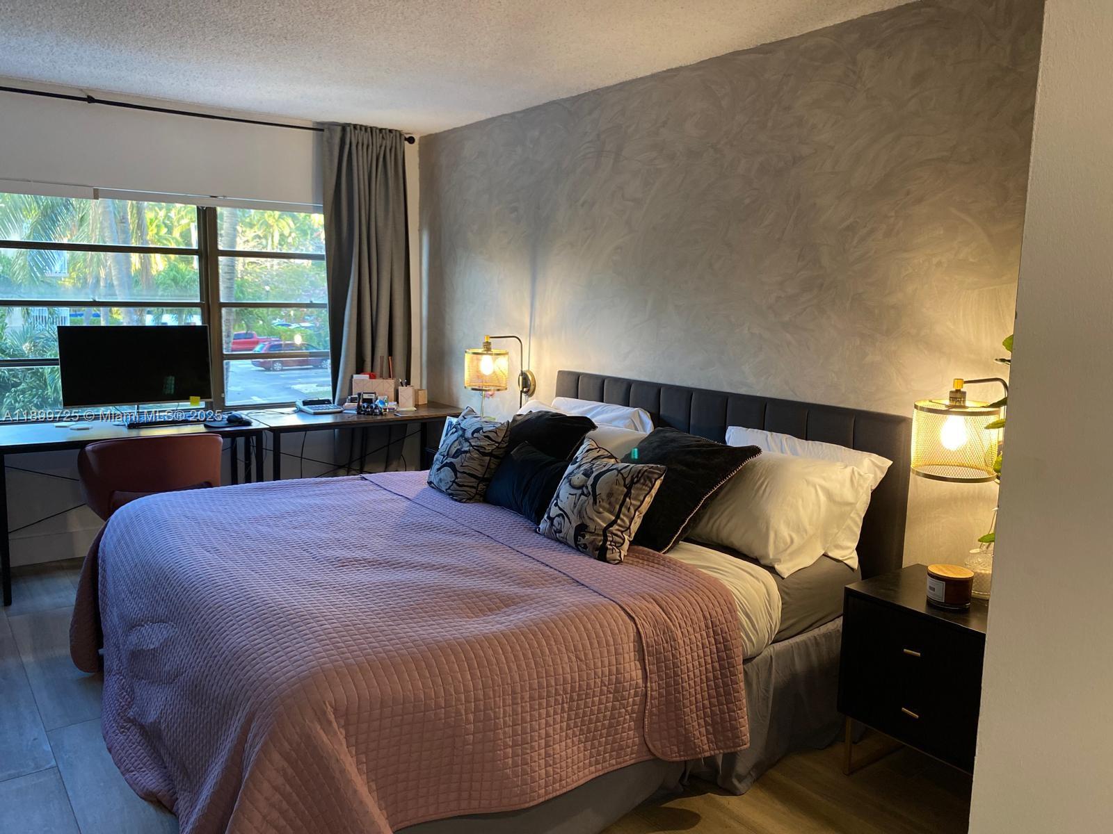 550 Ocean Drive, Unit 2D Key Biscayne, FL 33149 - Photo 23 of 35 a bedroom with a bed window and tv on table