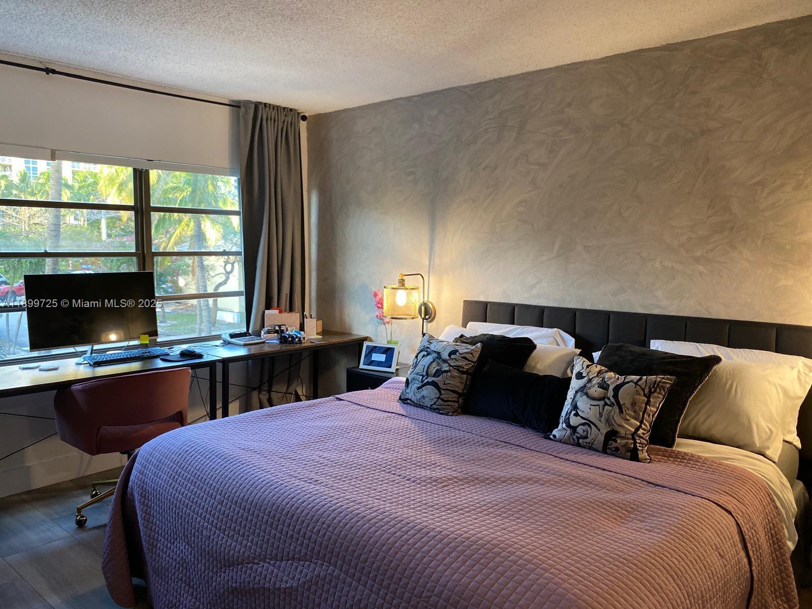 550 Ocean Drive, Unit 2D Key Biscayne, FL 33149 - Photo 24 of 35 a bedroom with a bed and a window