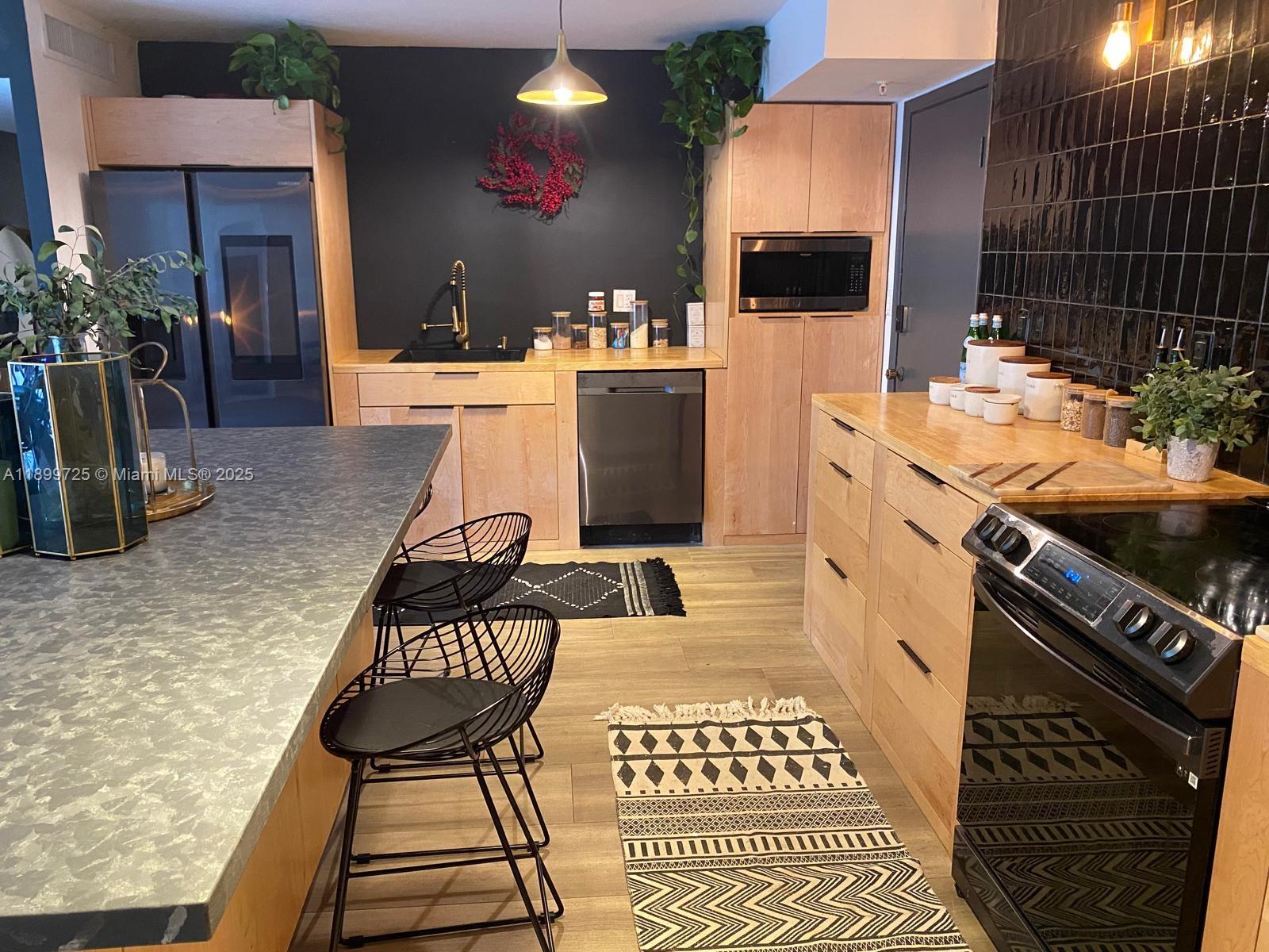 550 Ocean Drive, Unit 2D Key Biscayne, FL 33149 - Photo 4 of 35 a kitchen with a sink and cabinets