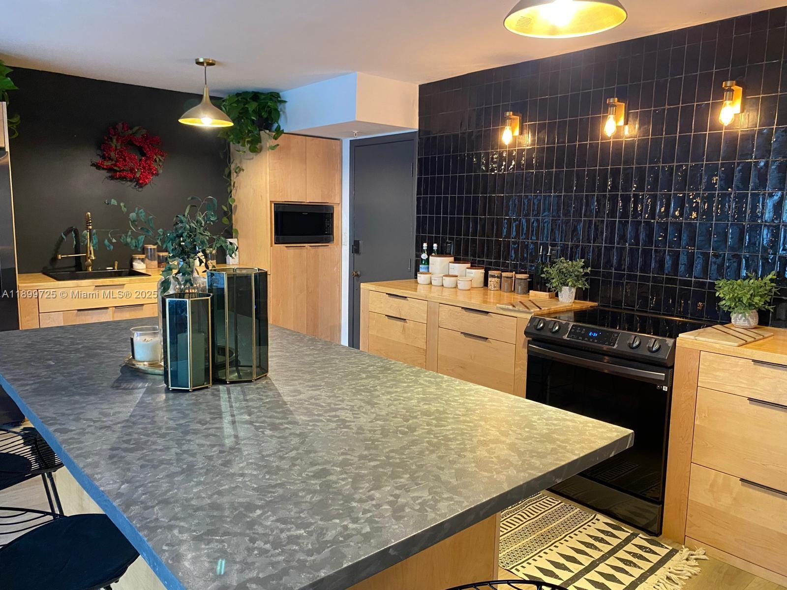 550 Ocean Drive, Unit 2D Key Biscayne, FL 33149 - Photo 5 of 35 a kitchen with a stove and a refrigerator