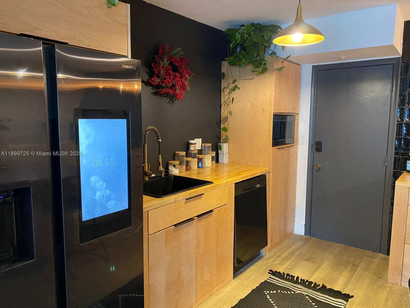 550 Ocean Drive, Unit 2D Key Biscayne, FL 33149 - Photo 6 of 35 a kitchen with stainless steel appliances granite countertop a refrigerator and a stove