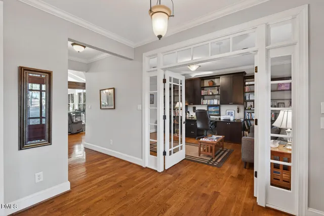 a living room with furniture a flat screen tv and kitchen view