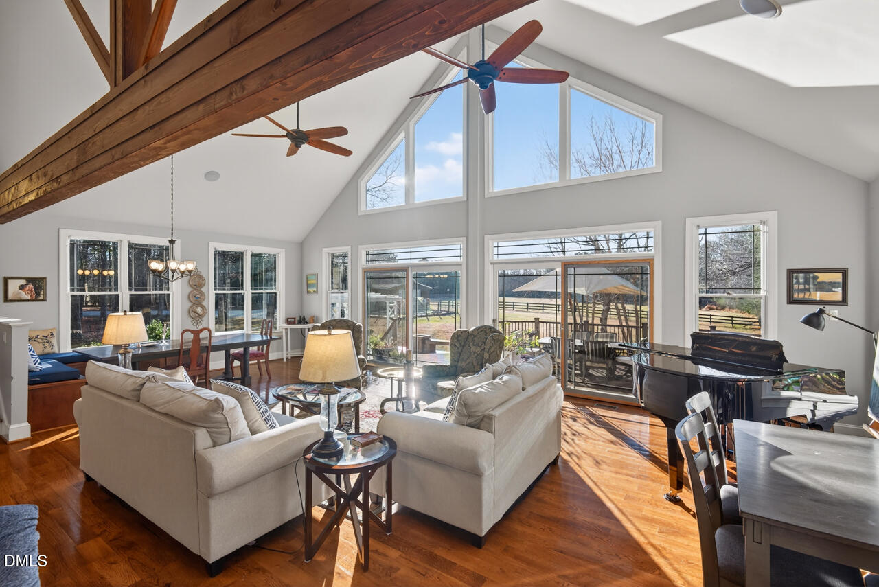 10775 Buffalo Creek Road Rougemont, NC 27572 - Photo 2 of 65 a living room with furniture and floor to ceiling windows