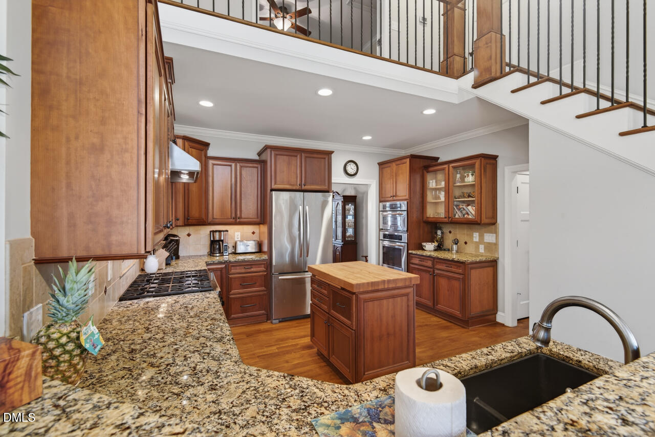 10775 Buffalo Creek Road Rougemont, NC 27572 - Photo 26 of 65 a kitchen with a refrigerator and a stove