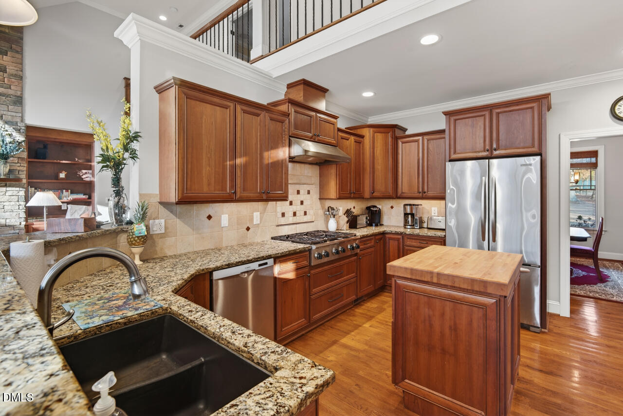 10775 Buffalo Creek Road Rougemont, NC 27572 - Photo 27 of 65 a kitchen with stainless steel appliances granite countertop a sink stove and refrigerator