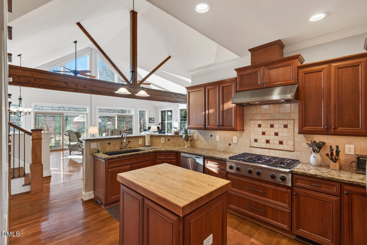 10775 Buffalo Creek Road Rougemont, NC 27572 - Photo 28 of 65 a kitchen with stainless steel appliances granite countertop a stove a sink dishwasher and cabinets with wooden floor