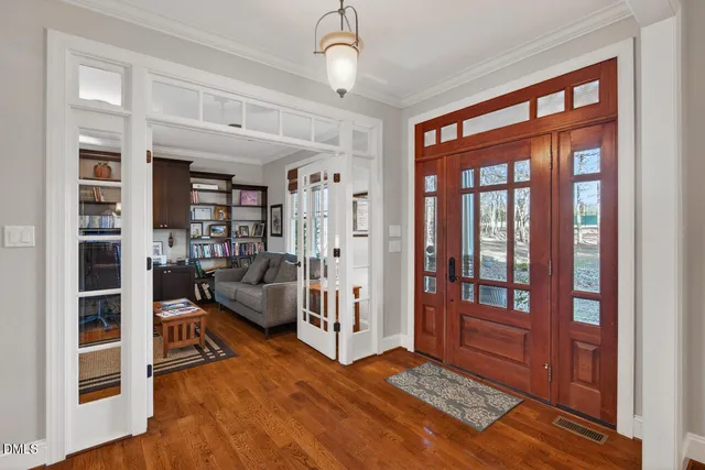 a living room with furniture hardwood floor and a chandelier