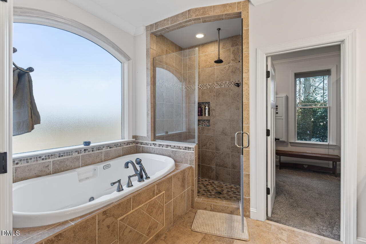 10775 Buffalo Creek Road Rougemont, NC 27572 - Photo 32 of 65 a bathroom with a bathtub and a shower