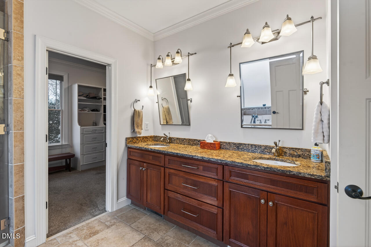 10775 Buffalo Creek Road Rougemont, NC 27572 - Photo 33 of 65 a spacious bathroom with a granite countertop sink and a mirror