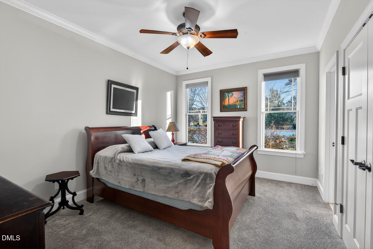 10775 Buffalo Creek Road Rougemont, NC 27572 - Photo 39 of 65 a bedroom with a bed and a chandelier