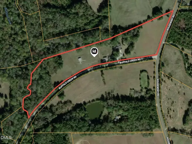 an aerial view of a house with a tennis court