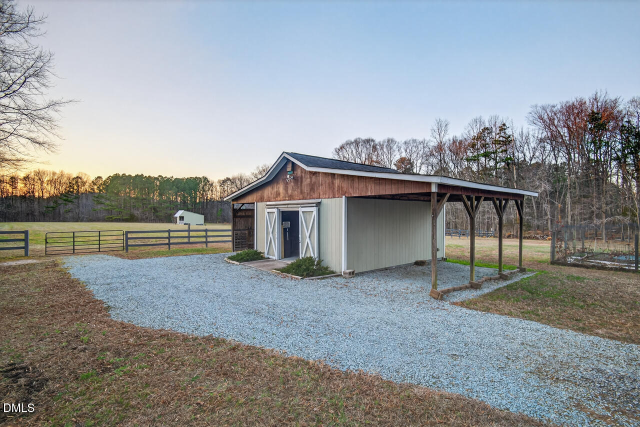 10775 Buffalo Creek Road Rougemont, NC 27572 - Photo 56 of 65 a view of a house with a yard and a large tree