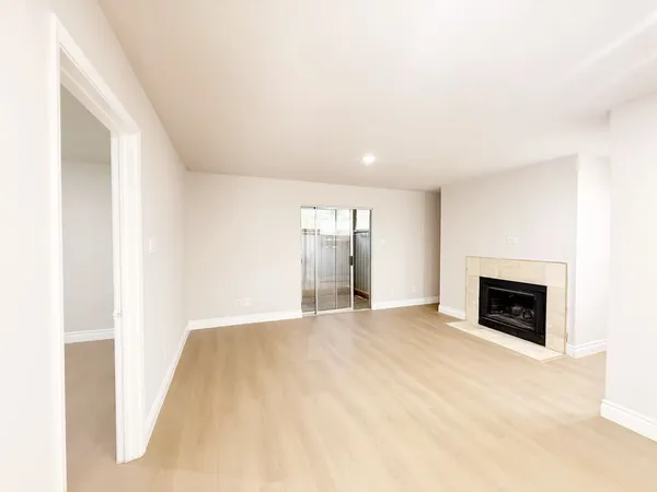 a view of empty room with a fireplace
