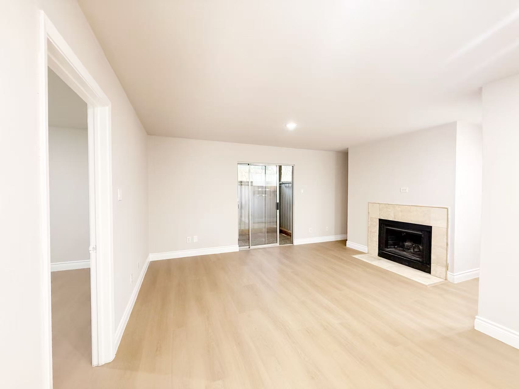 a view of empty room with a fireplace