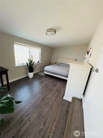 a hallway with wooden floor and furniture