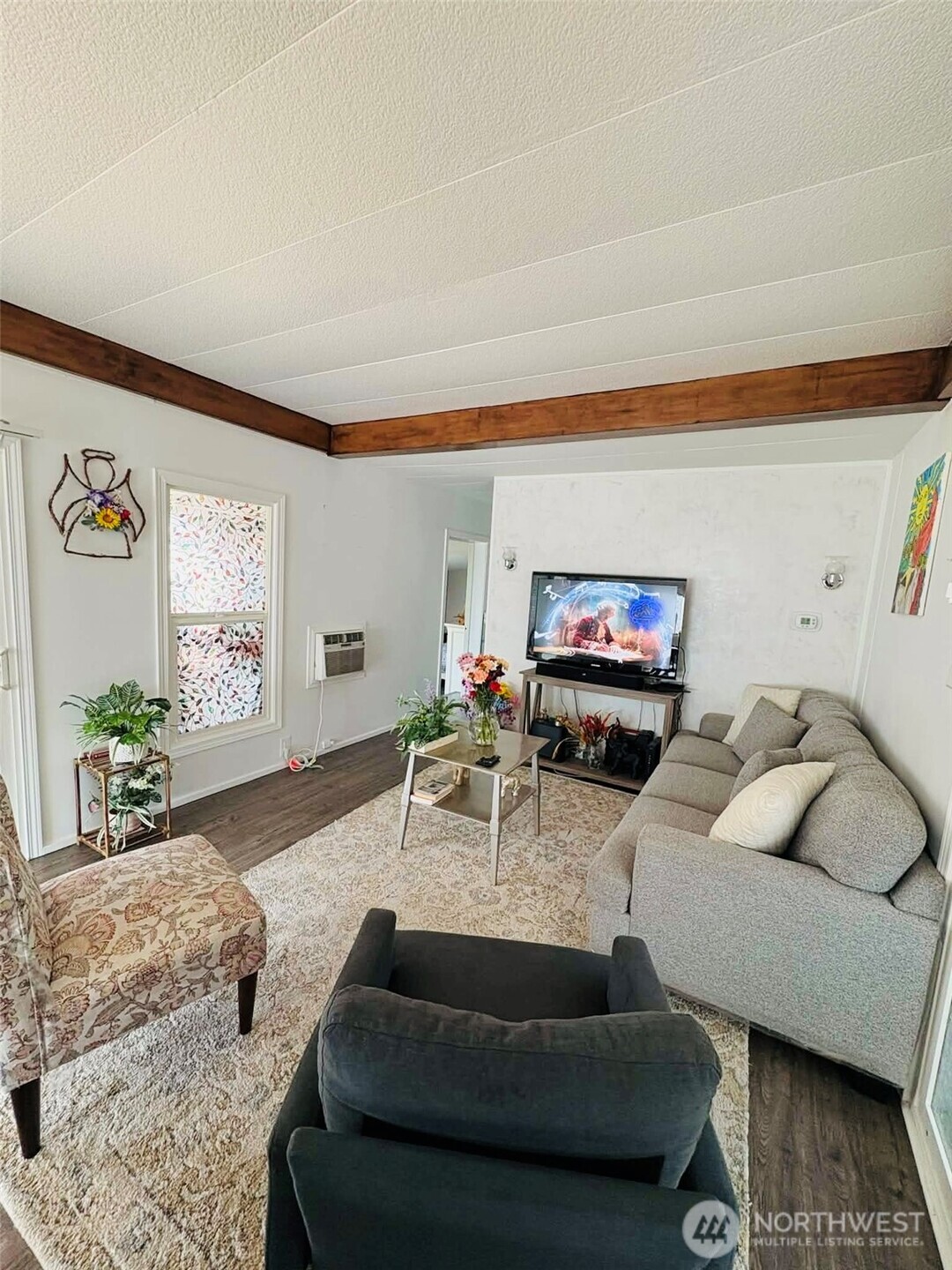 2302 R Street Southeast, Unit 125 Auburn, WA 98002 - Photo 13 of 20 a living room with furniture and a flat screen tv