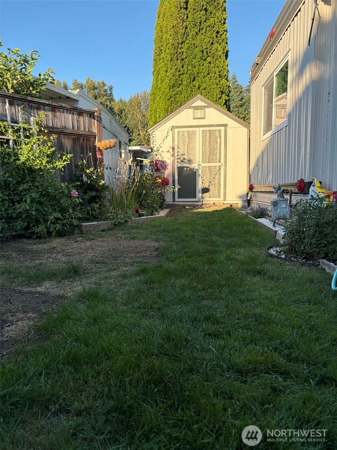 2302 R Street Southeast, Unit 125 Auburn, WA 98002 - Photo 17 of 20 a view of a house with a yard and sitting area