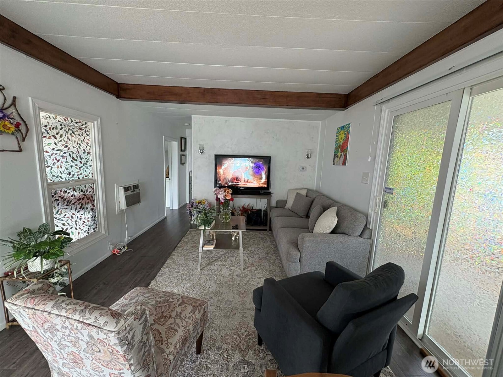 2302 R Street Southeast, Unit 125 Auburn, WA 98002 - Photo 4 of 20 a living room with furniture and a flat screen tv