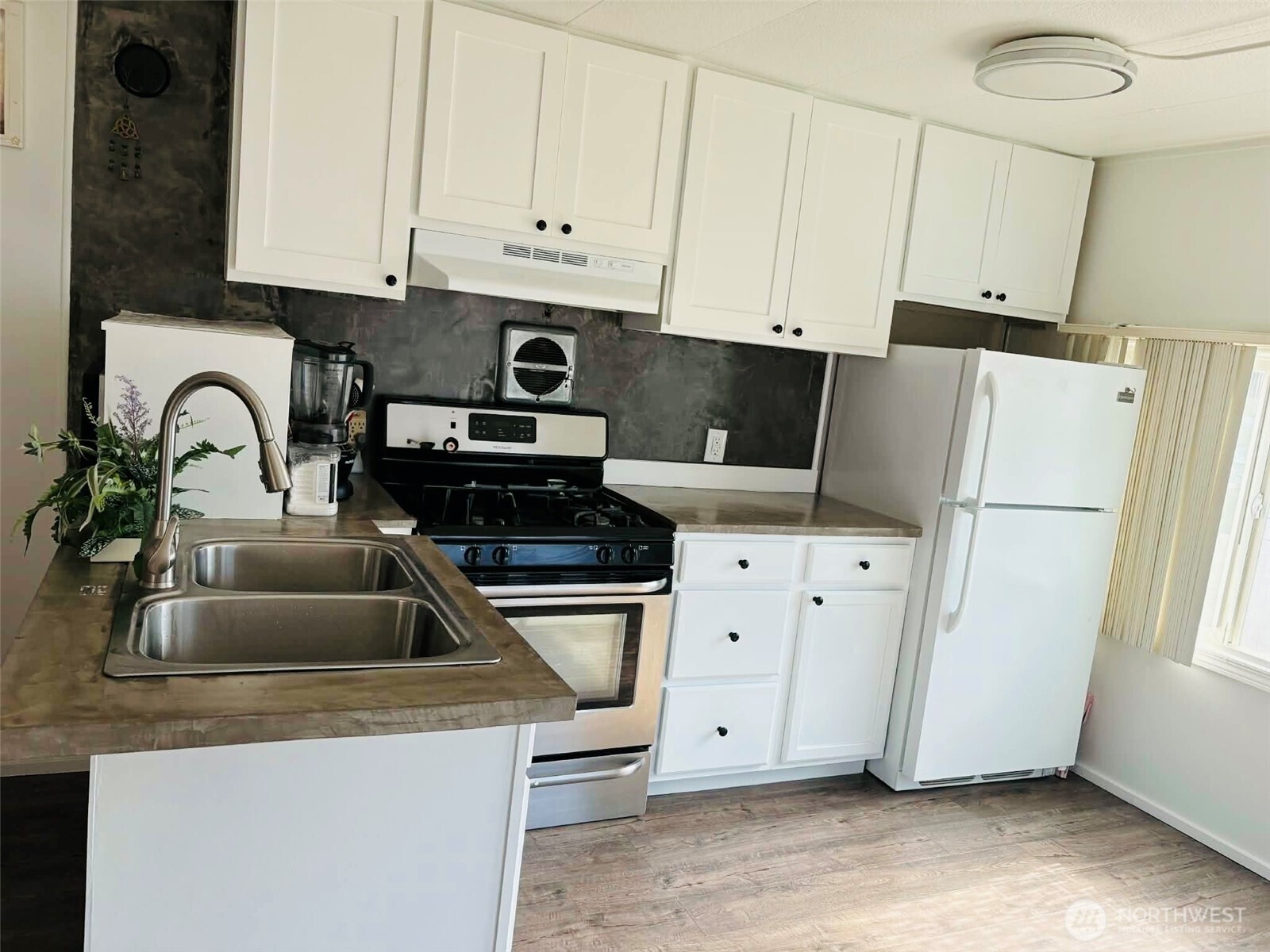 2302 R Street Southeast, Unit 125 Auburn, WA 98002 - Photo 8 of 20 a kitchen with appliances a sink and cabinets