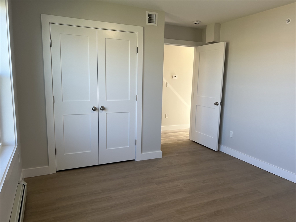 151 Shepard Street, Unit 14 Lynn, MA 01902 - Photo 11 of 22 a view of an empty room with wooden floor