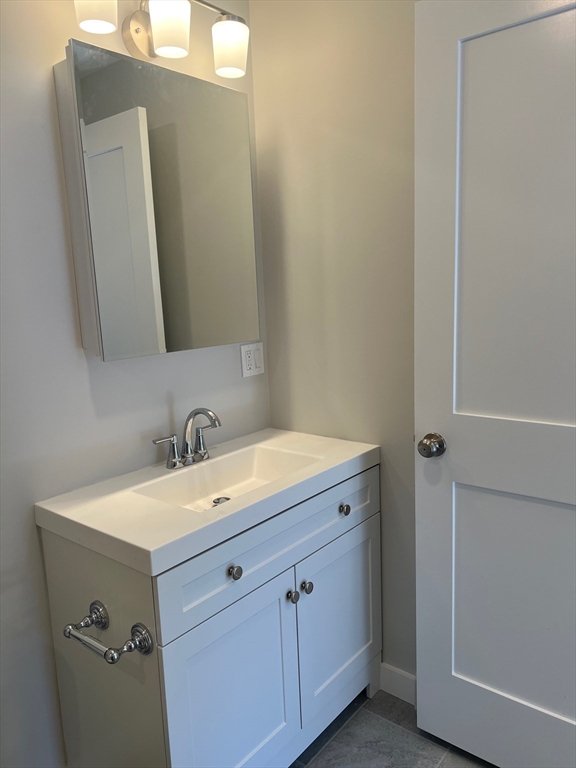151 Shepard Street, Unit 14 Lynn, MA 01902 - Photo 21 of 22 a bathroom with a sink and a mirror