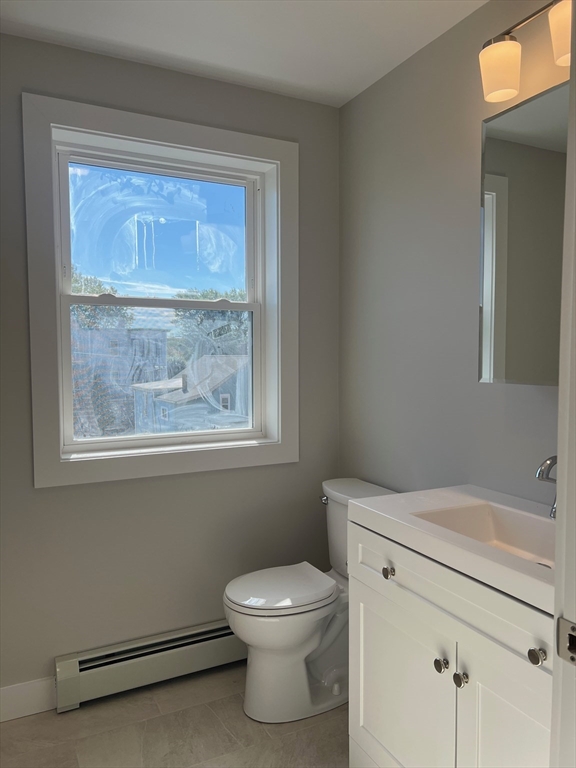 151 Shepard Street, Unit 14 Lynn, MA 01902 - Photo 8 of 22 a bathroom with a toilet a sink and a window